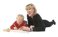 Photo of a child and his mom drawing and writing