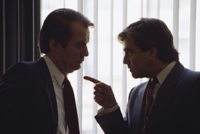 Silhouette photo of two men arguing.