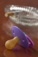 Photo of cigarette and a pacifier illustrating the dangers of secondhand smoke