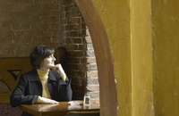Photo of a woman alone looking out the window