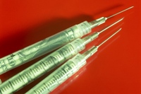 Money in syringes, illustrating the money mess
