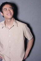 Photo of smiling young man looking up, illustrating looking for a wonderful future