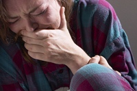 Tragedy in Newtown: Who's Really to Blame? (illustrated by crying, grief-striken woman)